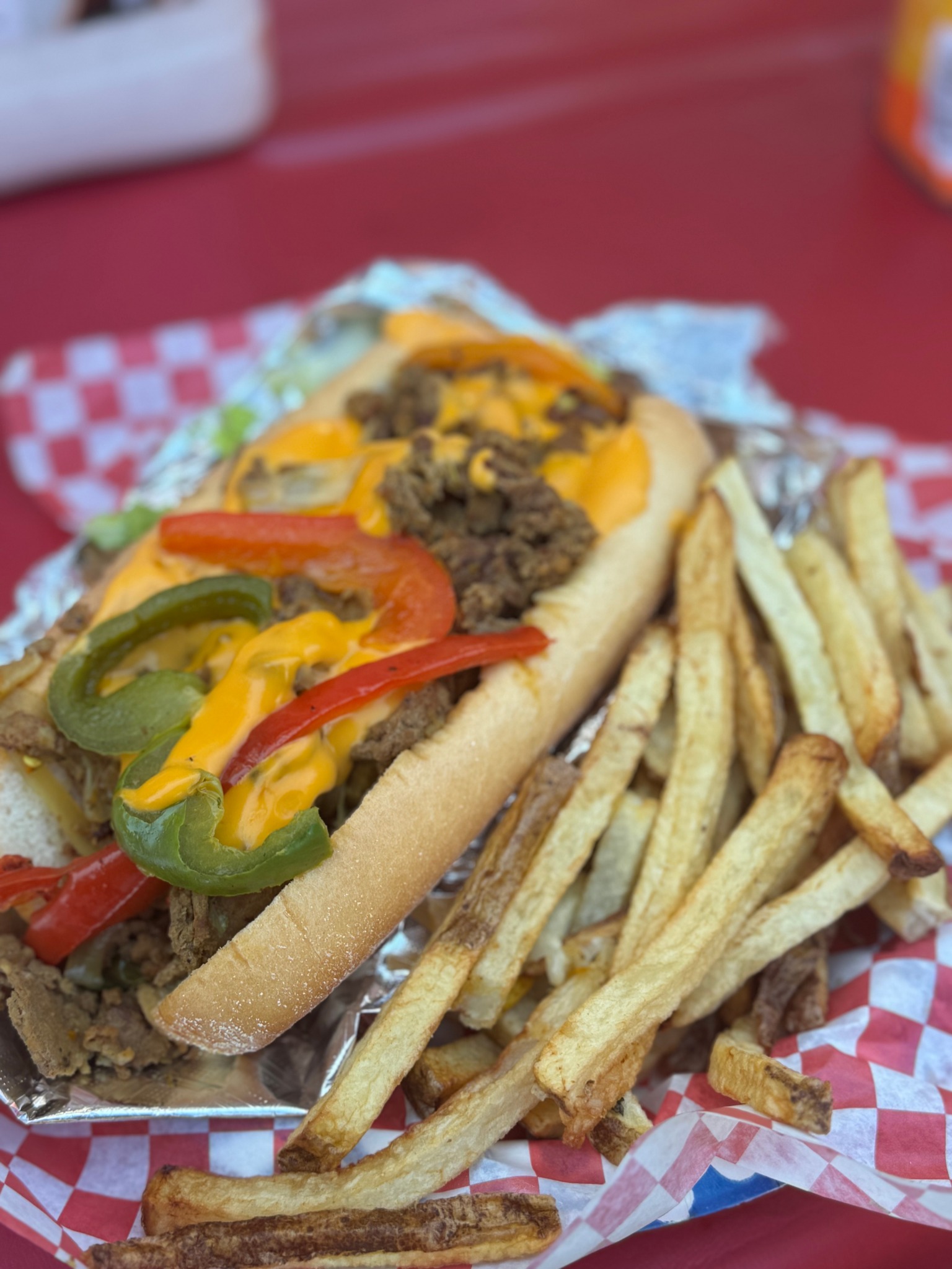 Philly cheesesteak with peppers and fries