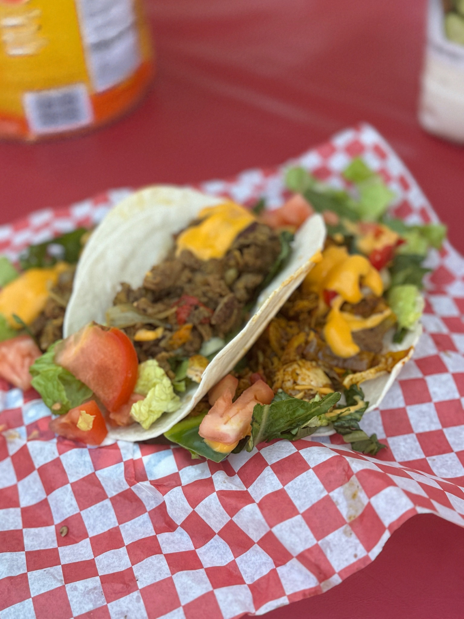 Tacos with cheese, lettuce and tomato